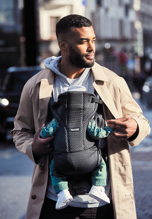 Photo of man carrying baby in babybjorn product