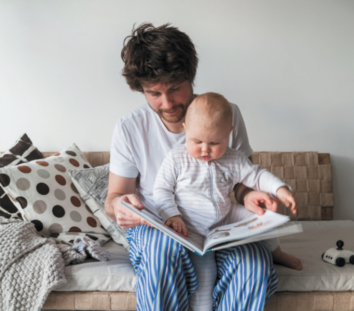 Man reading book with child